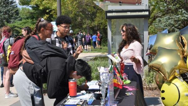 a group of people standing around a table